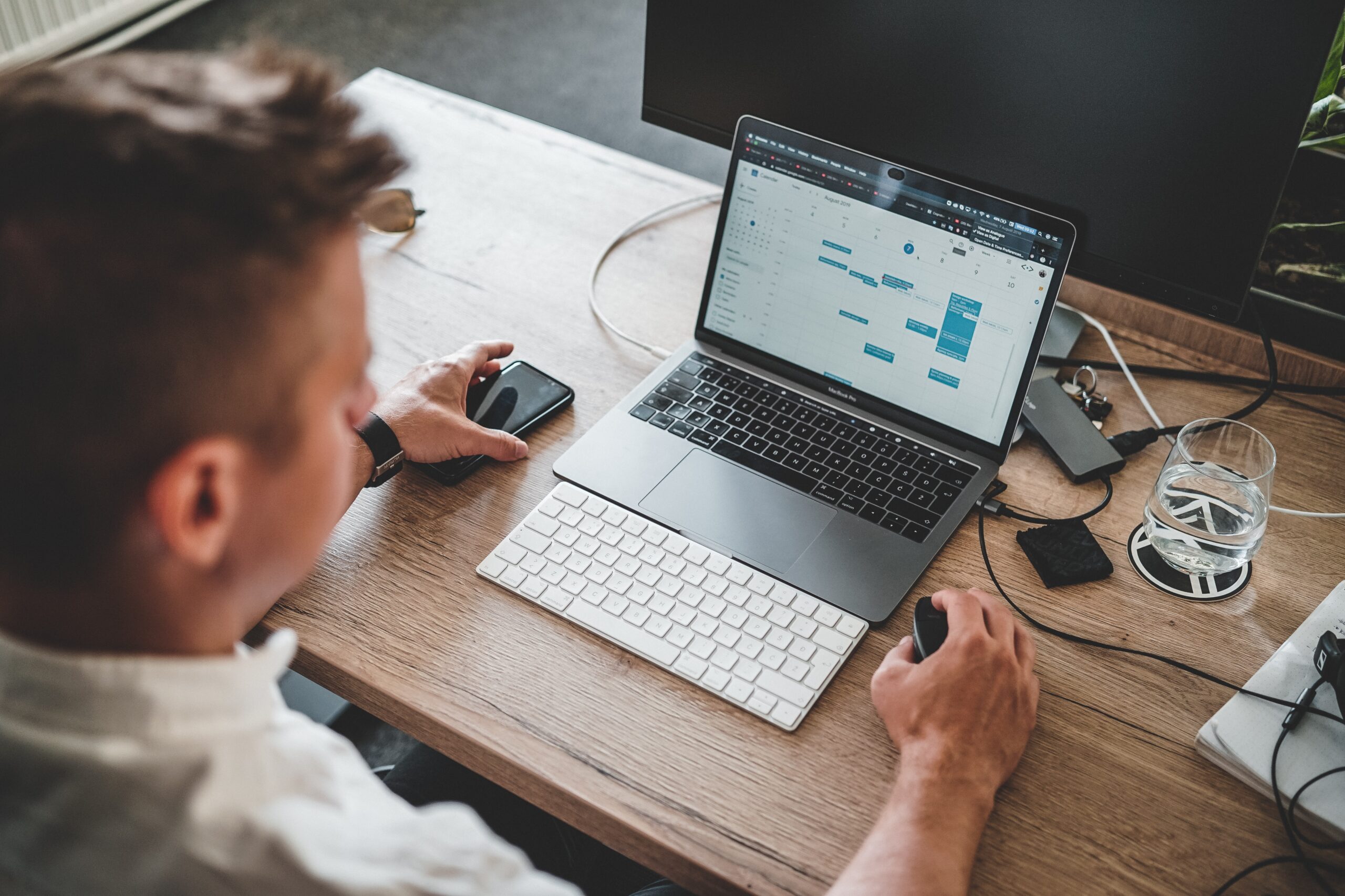 Software tester working on his laptop on his desk